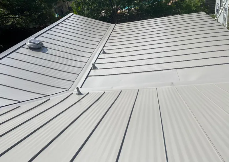 Solar attic fan installed on a metal roof for Roof Ventilation in Alexander City